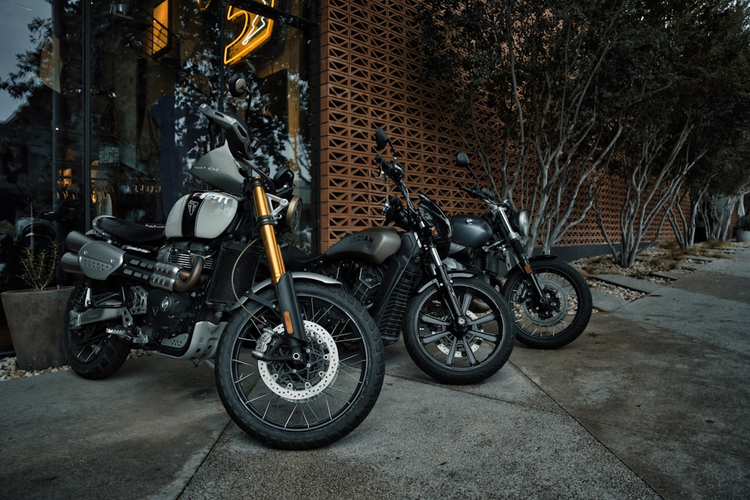 two-motorcycles-parked-next-to-each-other-in-front-of-a-building-r6r73svkbwu